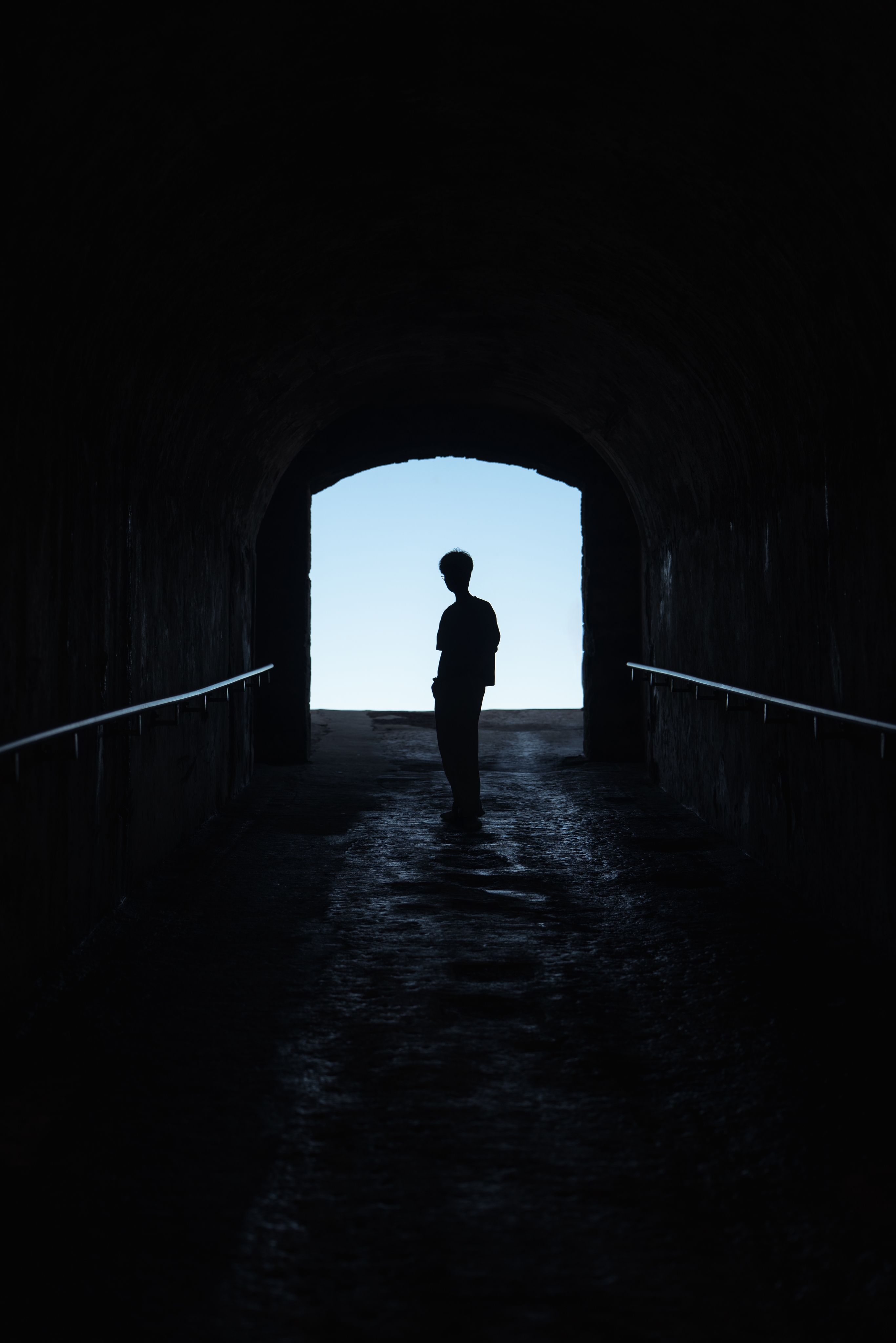 Silhouette of Raphael Peng standing in a tunnel