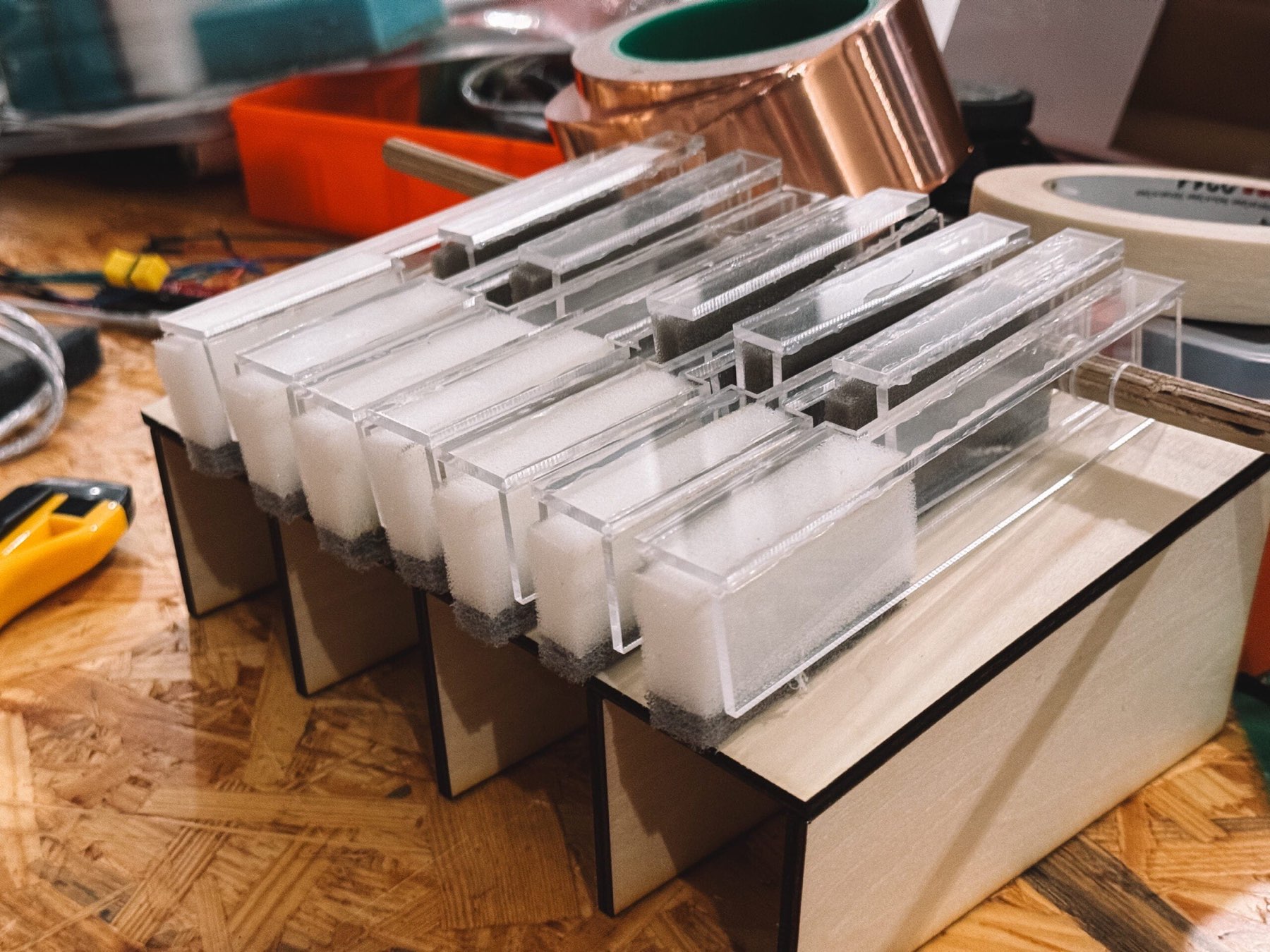 Transparent acrylic keys with copper tape during assembly