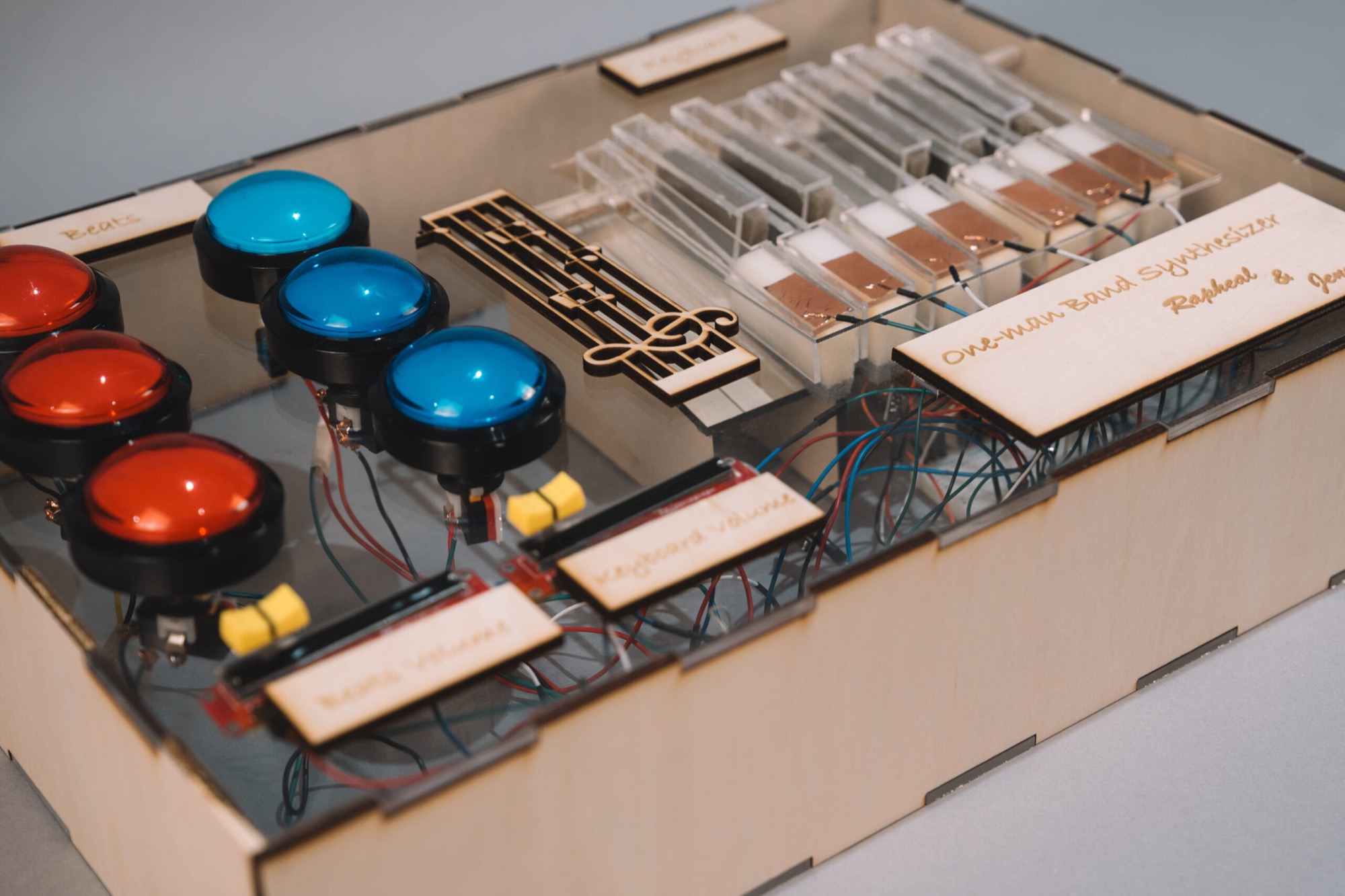One-Man Band - a laser-cut plywood synthesizer with arcade-button drum pads and transparent acrylic keys