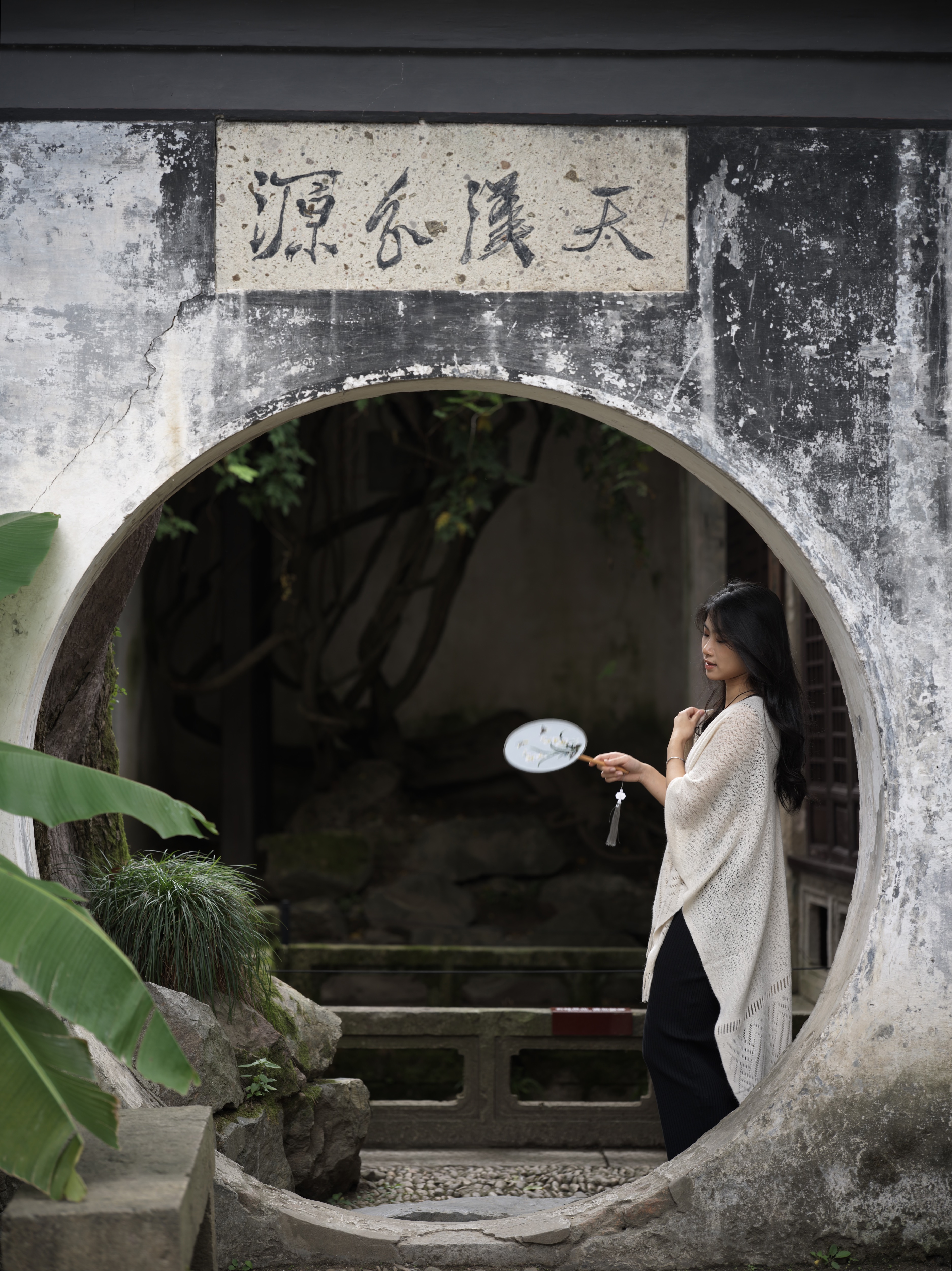 A round fan inside a moon gate, classical garden, Shaoxing, 2024
