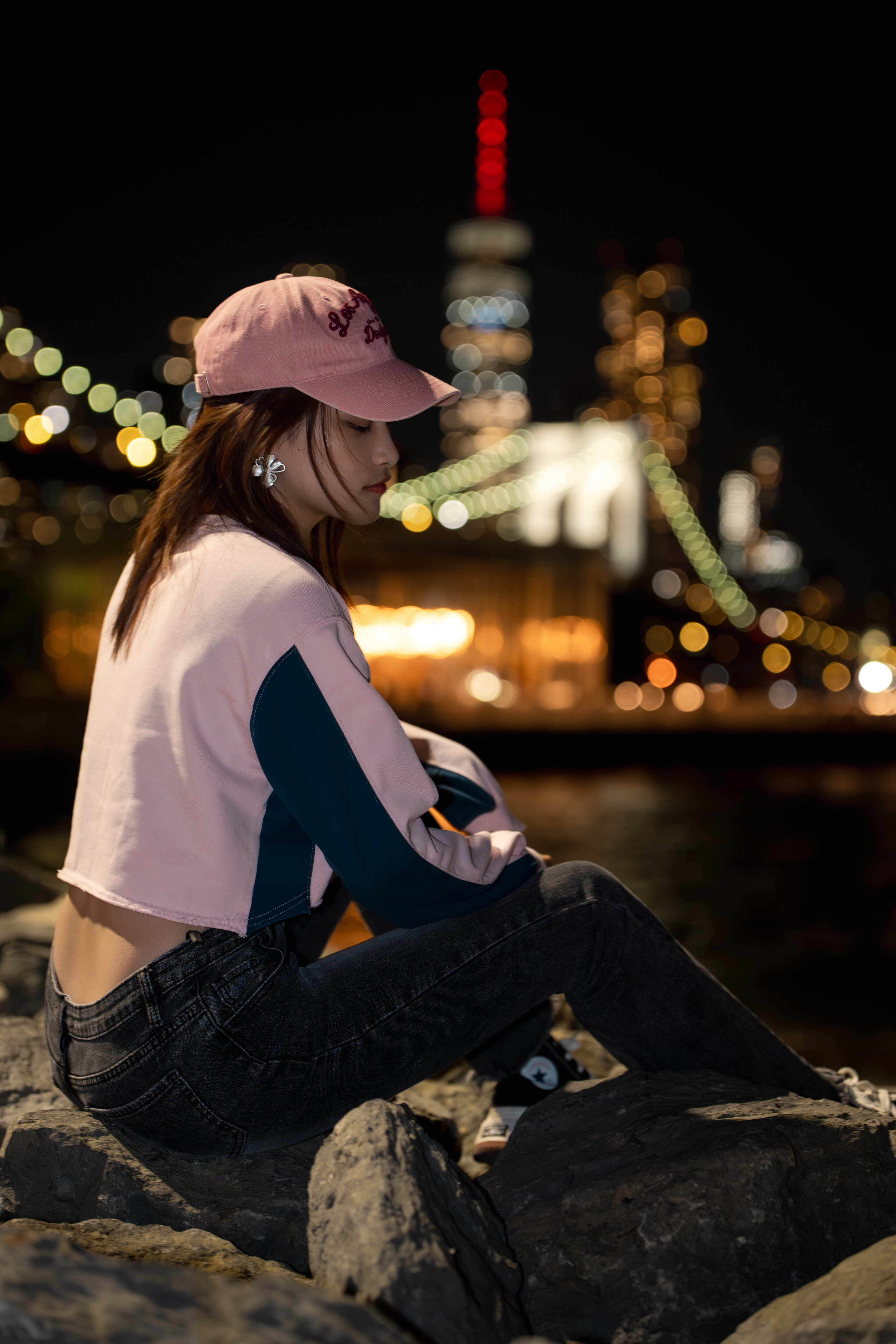 Night at the Brooklyn waterfront, lit skyline behind, New York, 2025