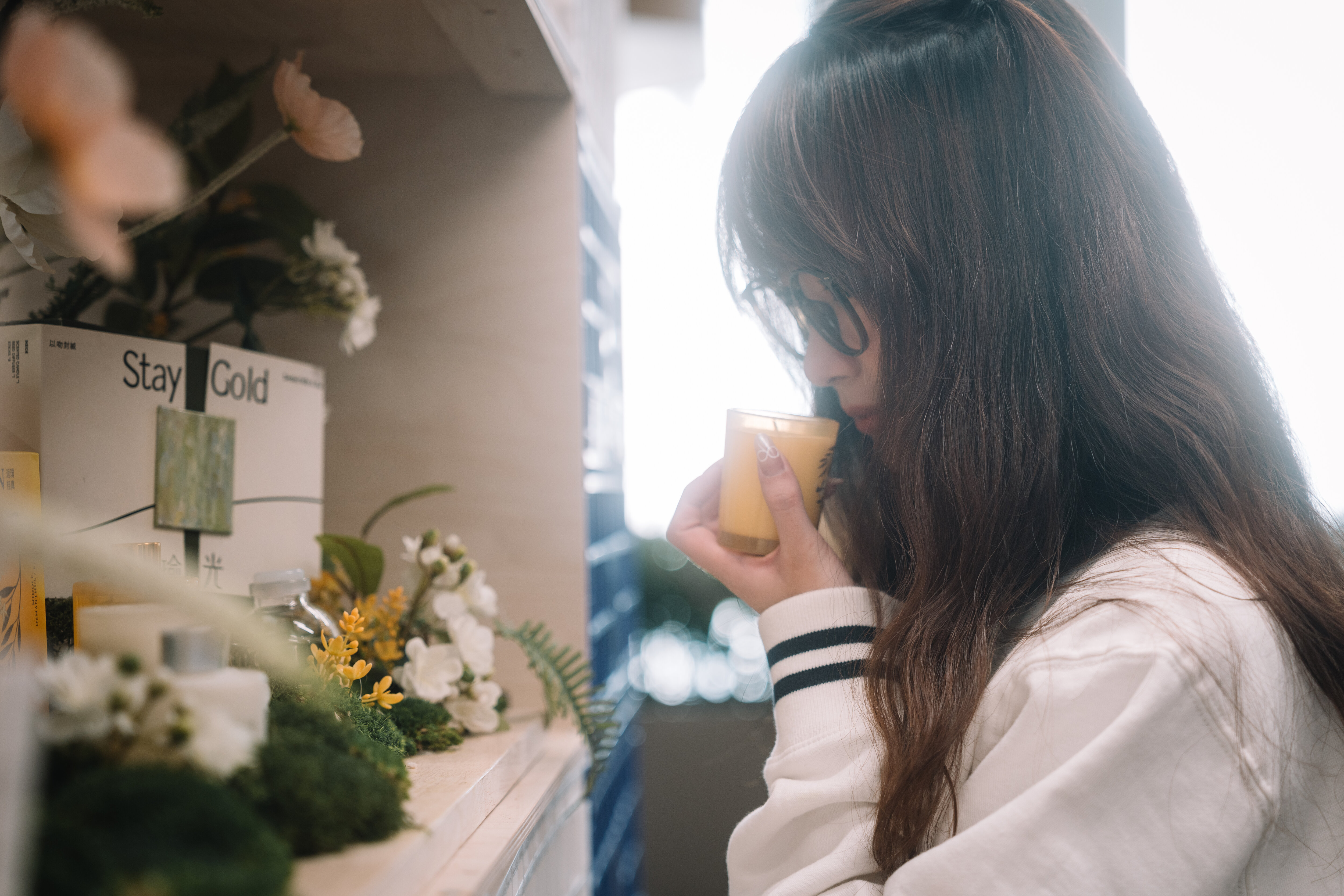A warm drink among the campus flower stalls, Shanghai, 2023