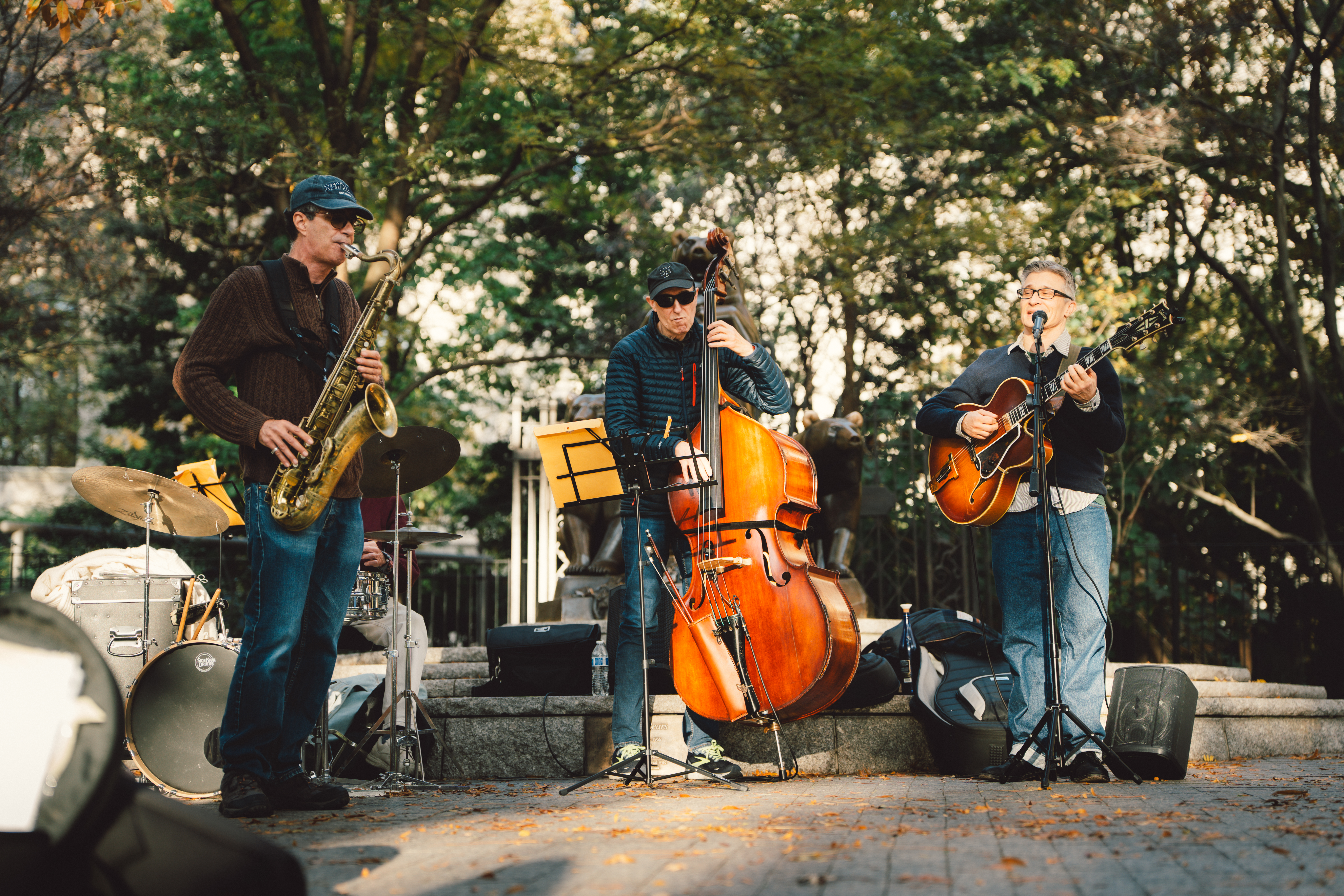 Three elderly musicians performing in Central Park
