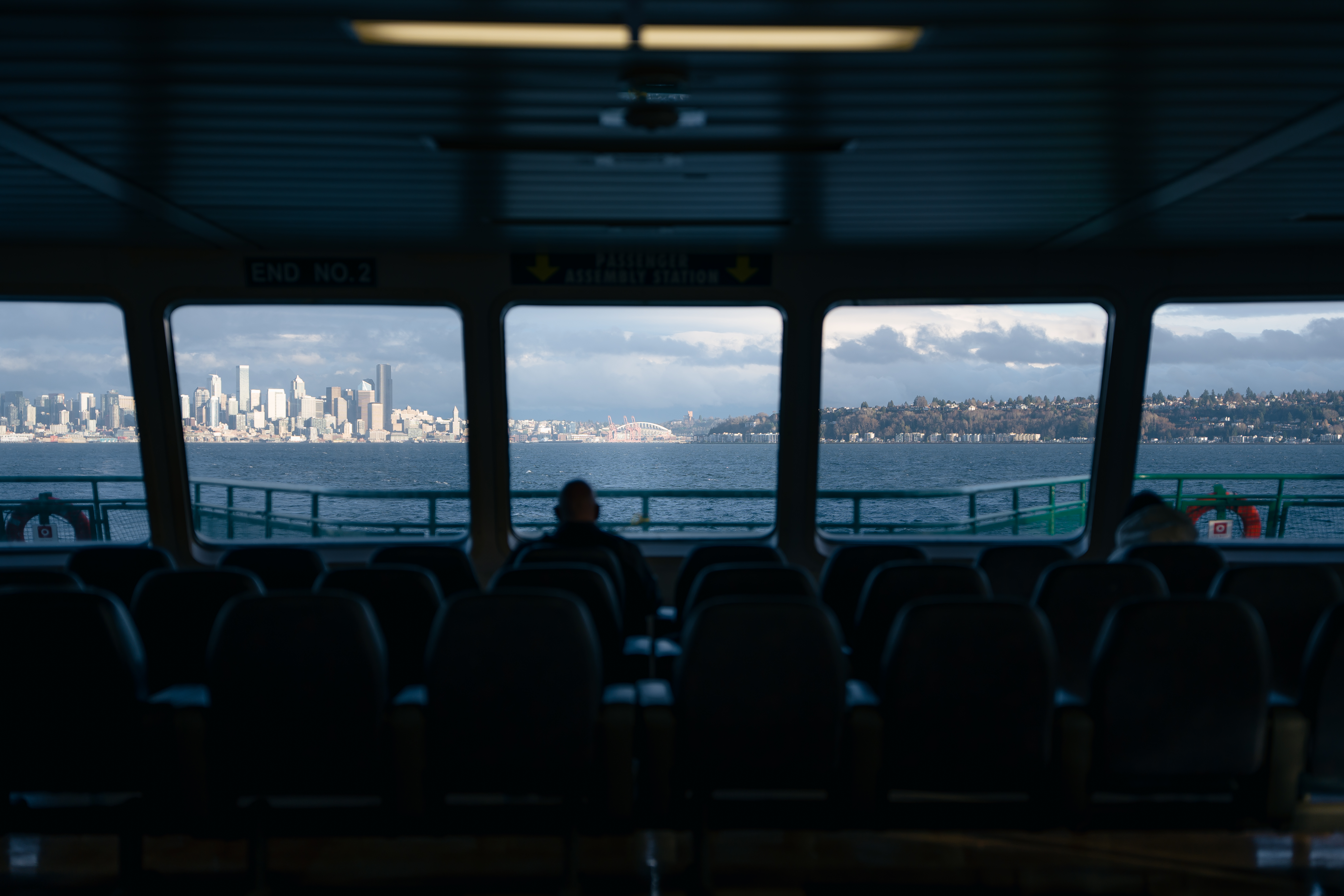 Elderly man at ferry bow watching skyline