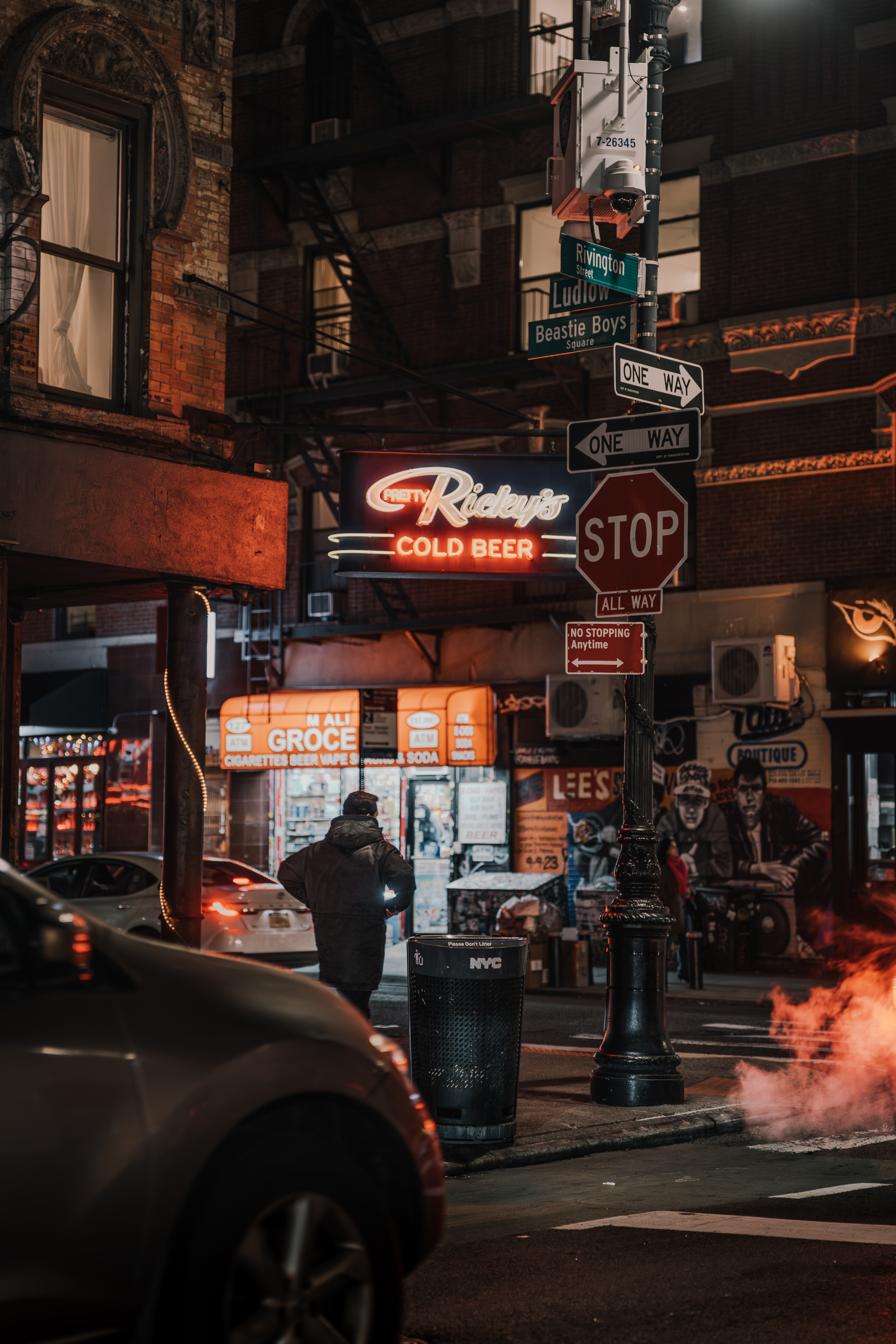Steam and street signs, figure with hands in pockets