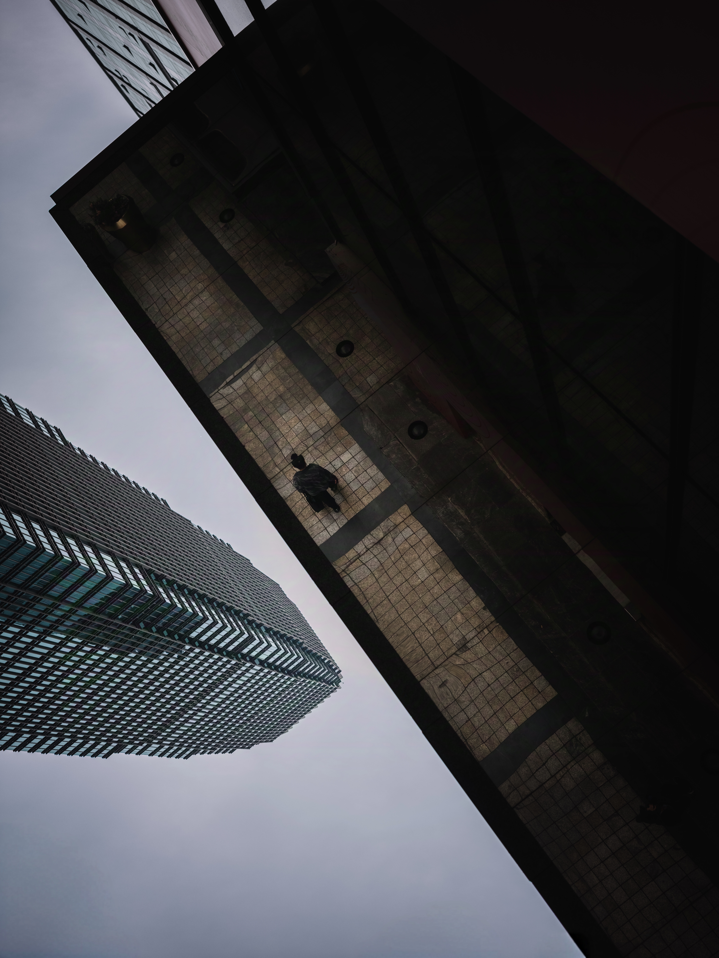 Reflection of skyscrapers and a silhouette walking in Jiefangbei, Chongqing